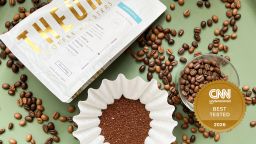 coffee beans and a coffee bag sitting on a green surface