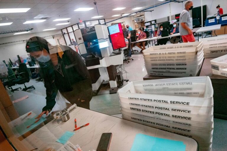 Poll workers count ballots inside the Maricopa County Election Department in Phoenix, Arizona, on November 5, 2020.