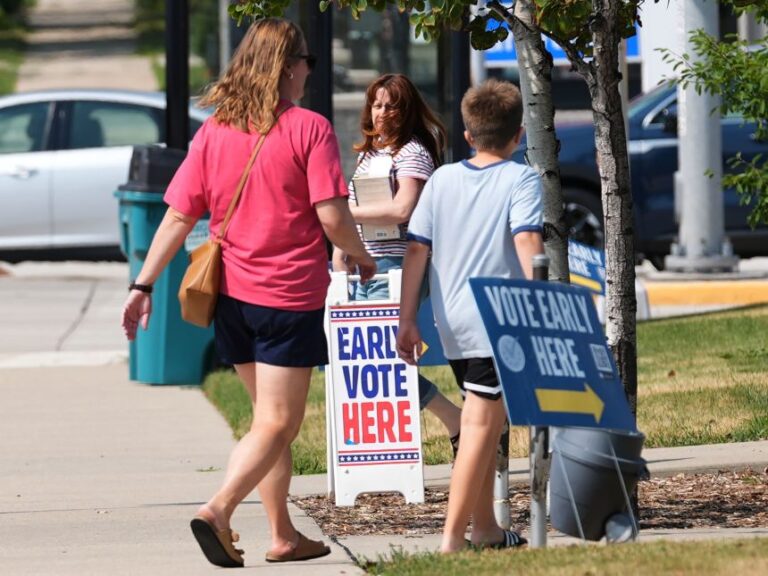 Voters arrive at a polling place in Milwaukee, Tuesday, July 28.