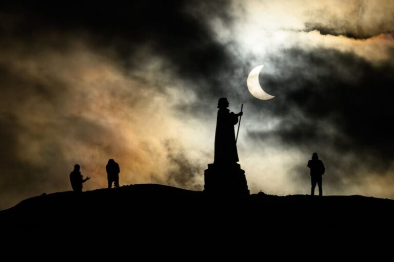 A statue is silhouetted during a partial solar eclipse on March 29, 2025, in Nuuk, Greenland.