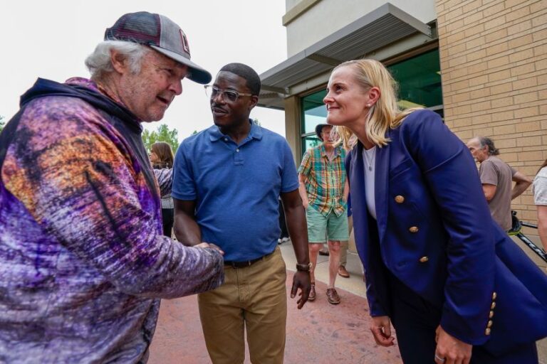 Democratic gubernatorial nominee David Crowley, center, and lieutenant governor nominee Sarah Godlewski, right, meet supporter Mike Balisle, left, following a breakfast with Democratic leaders in Middleton, Wisconsin, on Wednesday.