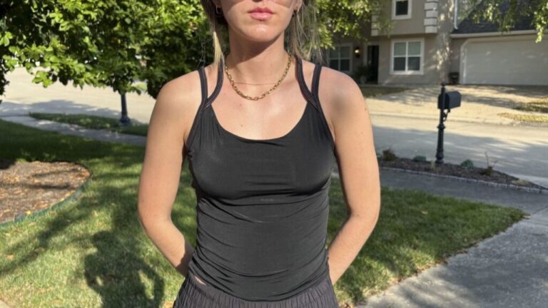 A woman wearing the cooling Spanx shelf tank.