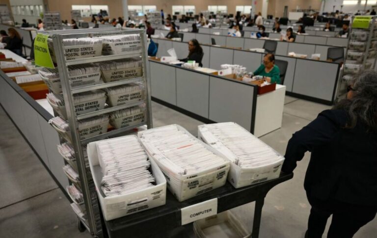 An election worker moves mail-in ballots to be organized for tabulation at the Los Angeles County Ballot Processing Center in City of Industry, California, on June 2.