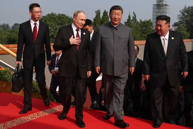 In this pool photograph distributed by the Russian state agency Sputnik, Russia's President Vladimir Putin walks with China's leader Xi Jinping and North Korea's leader Kim Jong Un before a military parade in Beijing's Tiananmen Square on September 3, 2025.