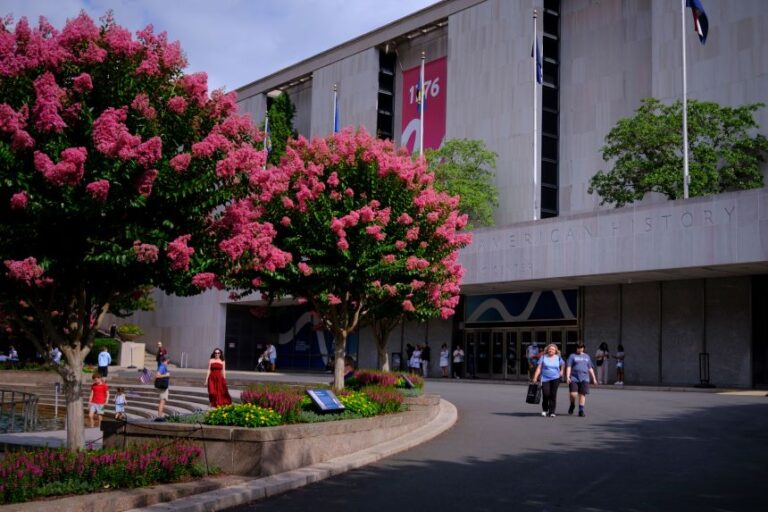 People walk past the entrance of the Smithsonian National Museum of American History in Washington, DC, on July 8, 2026.