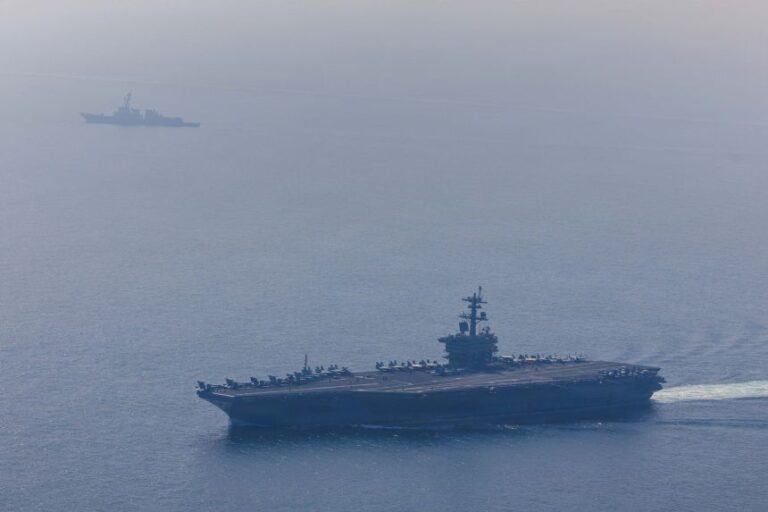 In this handout photo from the U.S. Defence Department, Nimitz-class aircraft carrier USS Abraham Lincoln (CVN 72) and Arleigh Burke-class guided-missile destroyer USS Frank E. Petersen Jr. (DDG 121) sail in the Arabian Sea, February 6, 2026.