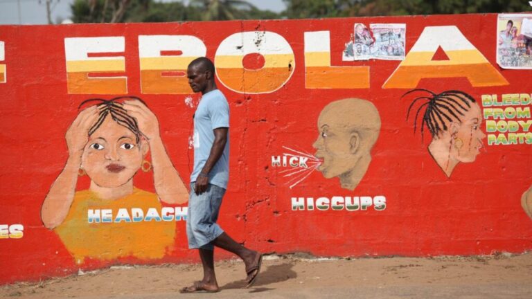 A man walks past an Ebola awareness painting in Monrovia on March 22, 2015.