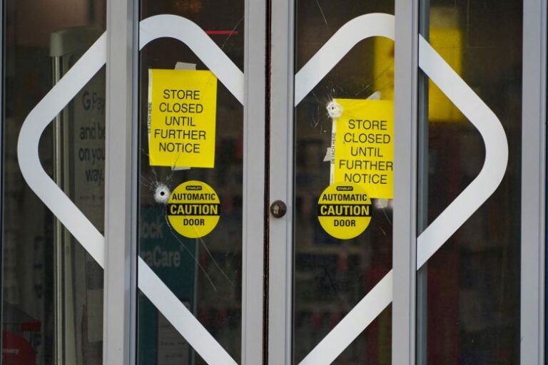 Bullet holes mark the glass at a CVS store across from CDC headquarters in Atlanta after the shooting.