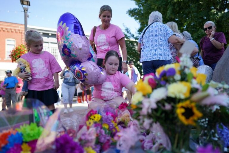 People visit a makeshift memorial honoring Dolly Parton in Sevierville, Tennessee, on Tuesday.