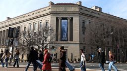 Tourists walk past the Department of Justice in Washington, DC, on February 27, 2026.