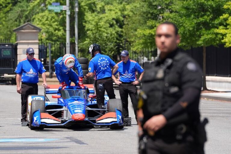 IndyCar Series driver David Malukas boards a race car on West Executive Drive at the White House during a showcase for the upcoming Freedom 250 Grand Prix auto race in Washington, on July 13.