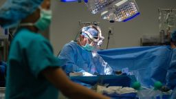 A doctor removes a liver from a donor in the operating room at OneLegacy on June 29, 2023, in Azusa, California.