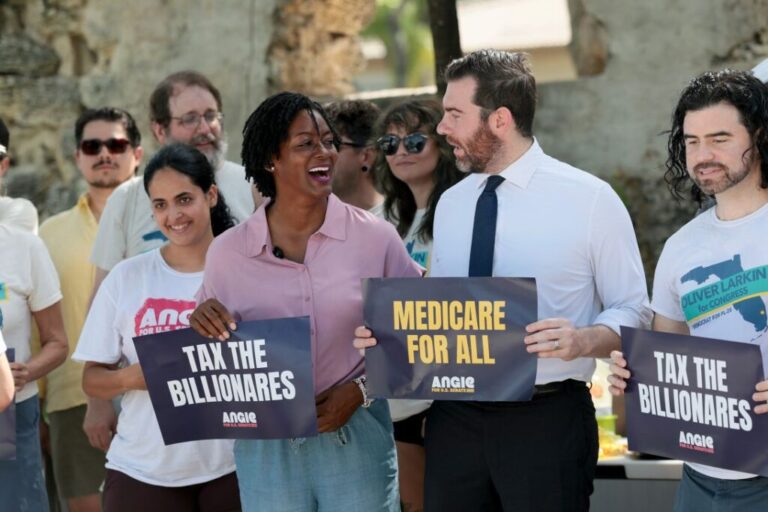 Democratic US Senate candidate and Florida state Rep. Angie Nixon, center left, stands with Florida Democratic congressional candidate Oliver Larkin, center right, in North Miami Beach, Florida, on August 15.