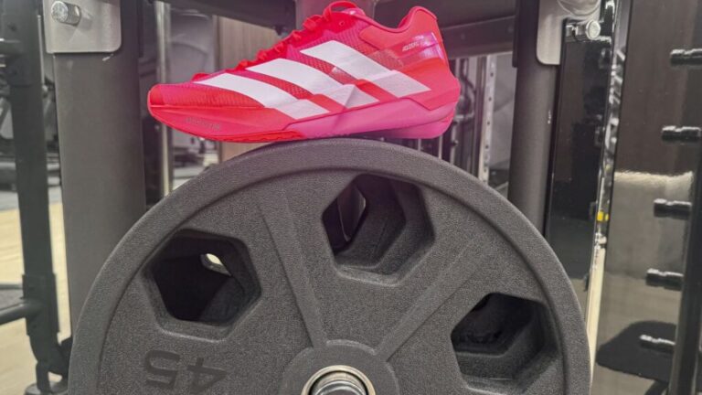 Adidas Adizero Primo weightlifting shoes sitting on top of weights.