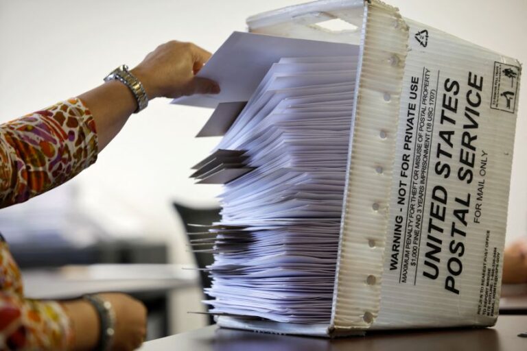 An election worker prepares absentee ballots for the upcoming general election before they are mailed to voters, at Wake County Board of Elections headquarters in Raleigh, North Carolina, on September 5, 2024.