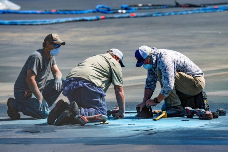 Crews work on the coating of the Lincoln Memorial Reflecting Pool on the National Mall on August 26.