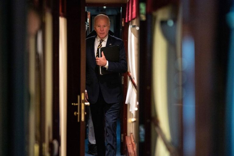 US President Joe Biden walks down a train corridor to his cabin after a surprise visit with Ukrainian President Volodymyr Zelenskyy, in Kyiv on February 20, 2023. - Biden took a nearly 10-hour train ride from Poland into Kyiv. (Photo by Evan Vucci / POOL / AFP) (Photo by EVAN VUCCI/POOL/AFP via Getty Images)