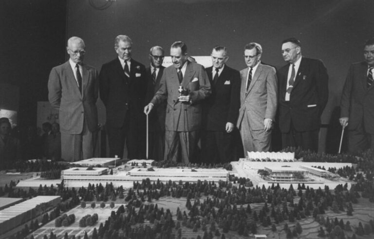 On January 1, 1955, Secretary of the Air Force, Harold Talbott, center, pointed out features on a model of the Air Force Academy that was to be constructed later that year.