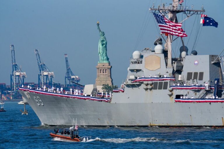 US Navy's Arleigh Burke-class destroyer USS Farragut (DDG-99) sails by the Statue of Liberty ahead of the Sail4th 250 parade of ships in New York Harbor for the United States 250th anniversary on Independence Day in New York on July 4.