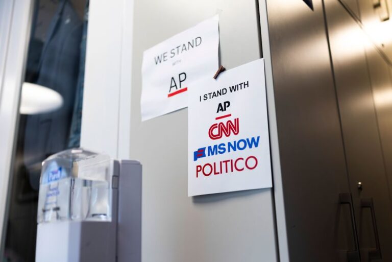 Signs of support for AP, CNN, MS NOW and Politico hang on the White House grounds on September 21 in Washington, DC.