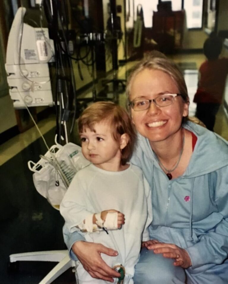 Two-year-old Olivia is hugged by her mother Sheila before undergoing surgery to remove her colon.