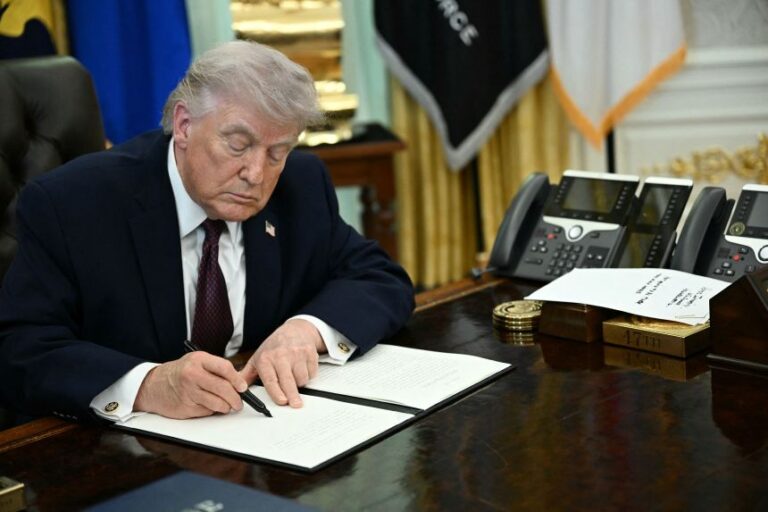 President Donald Trump signs an executive order cracking down on mail-in voting ahead of midterm elections in the Oval Office of the White House in Washington, DC, on March 31.