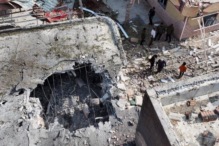 People inspect damage and debris at a building that Iranian media said was hit by a US strike while a wedding celebration was taking place there, in Kuhestak, southern Iran, near the Strait of Hormuz, on Wednesday, Sept. 2.