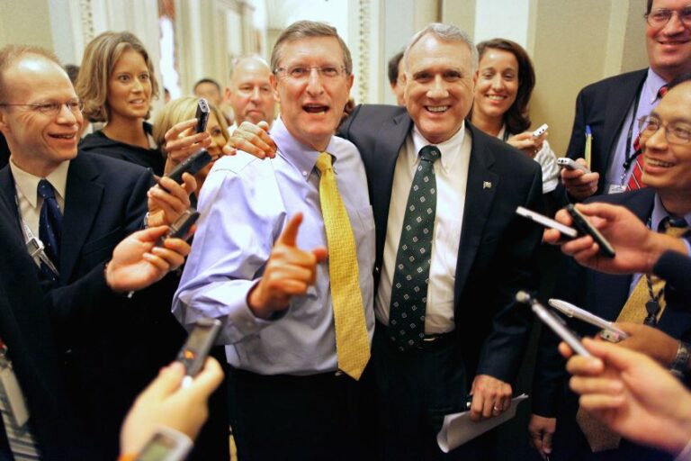 Senate Budget Committee Chairman Sen. Kent Conrad, left, and Senate Minority Whip Sen. Jon Kyl embrace after leaving their respective caucus meetings in the US Capitol July 25, 2011 in Washington, DC.