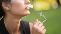 Close up of a woman smoking marijuana