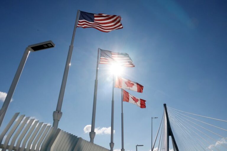 Flags of Canada and United States fly across the international border on the Gordie Howe International bridge that connects Windsor, Ontario, and Detroit, Michigan, on September 6.