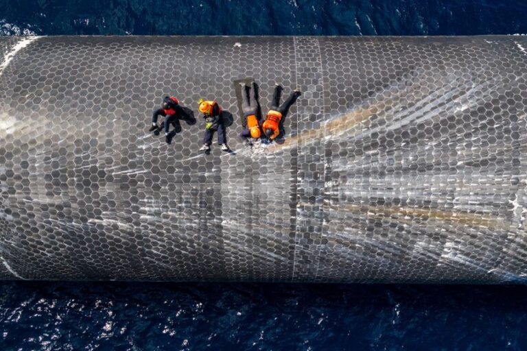 This image provided by SpaceX on August 27 shows engineers inspecting Starship off the coast of Christmas Island in the Indian Ocean, following its test flight in July. (SpaceX via AP)