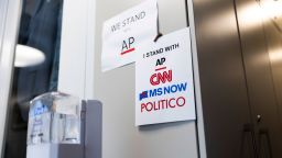Signs of support for AP, CNN, MS NOW and POLITICO hang on the White House grounds on September 21 in Washington, DC.