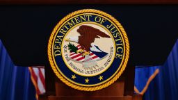 The seal of the US Department of Justice is displayed on a podium at the Department of Justice headquarters in Washington, DC, on April 7.