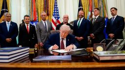 President Donald Trump signs an executive order about easing restrictions on mental health treatments, including, ibogaine, in the Oval Office of the White House in Washington, DC, on April 18.