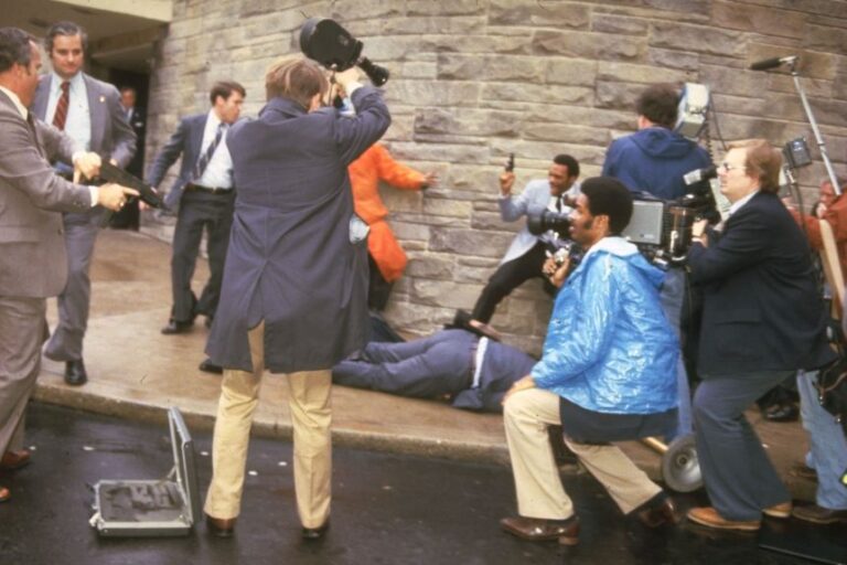 Armed Secret Service agents and journalists surround White House Press Secretary James Brady after he was shot outside the Washington Hilton Hotel, Washington DC, March 30, 1981. He was shot during an assassination attempt against President Ronald Reagan.