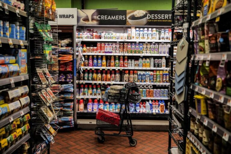 A shopping cart stands in an aisle of a grocery store in New York City, on August 26.