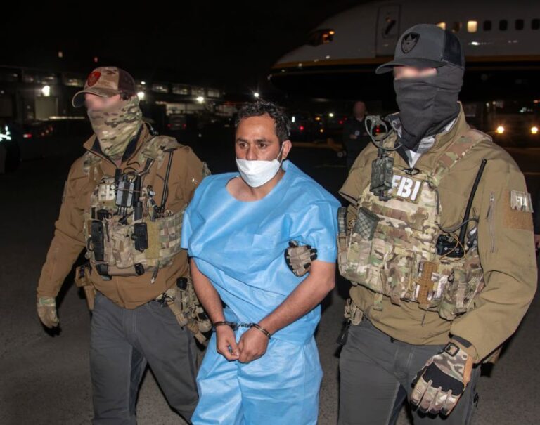This photo posted to the social media platform X on March 5 by FBI Director Kash Patel shows Mohammad Sharifullah being escorted from a plane by two FBI officers. Editor's note: Portions of the faces of the FBI officers have been obscured by the FBI.
