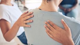 Hands, mental health and support in group therapy for woman suffering depression, stress and trauma closeup. Hand, people and aa meeting by community in trust, help and empathy for girl with anxiety