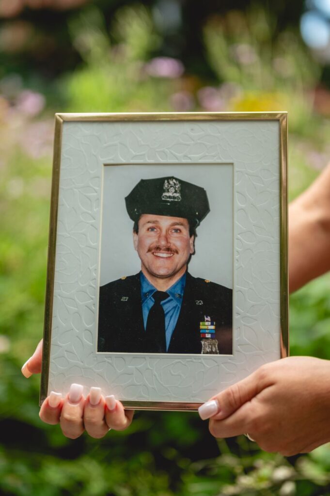 Leah Betso holds a photo of her father, James Betso.