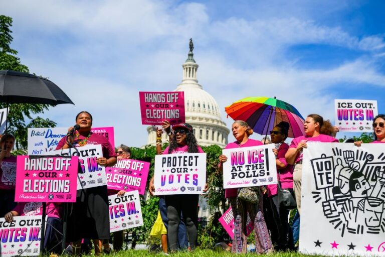Demonstrators hold signs during a voting rights rally outside the US Capitol in Washington DC, on September 15.