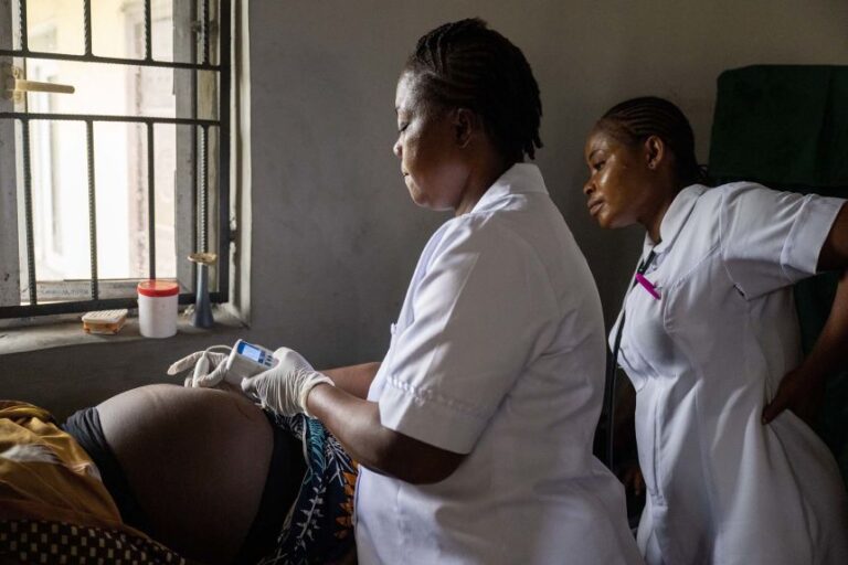 Nurses at a prenatal clinic at Okrika Zonal Hospital in Rivers State, Nigeria check on the health of a mother and baby. This clinic is specifically for women living with HIV and provides them with medication, education, and encouragement to deliver HIV-free babies.
