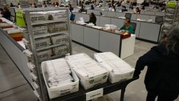 An election worker moves mail-in ballots to be organized for tabulation at the Los Angeles County Ballot Processing Center in City of Industry, California, on June 2.