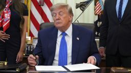 President Donald Trump prepares to sign an executive order about vaccines, Monday, Aug. 10, 2026, in the Oval Office of the White House in Washington. (AP Photo/Jacquelyn Martin)