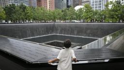 A child looks at the south tower reflecting pool memorial at the National 9/11 Memorial and Museum in New York, on August 31.