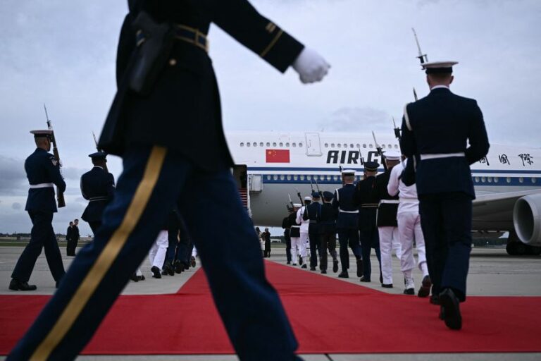 US military personnel walk into position next to a red carpet at the bottom of the stairs of an Air China plane carrying Chinese President Xi as he arrives at Joint Base Andrews, Maryland, on Wednesday.