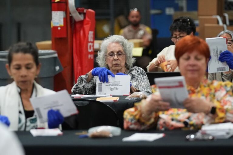 Election workers sort vote-by-mail ballots at the Miami-Dade County Supervisor of Elections Office for the Florida primary election in Doral, Florida, on August 18.