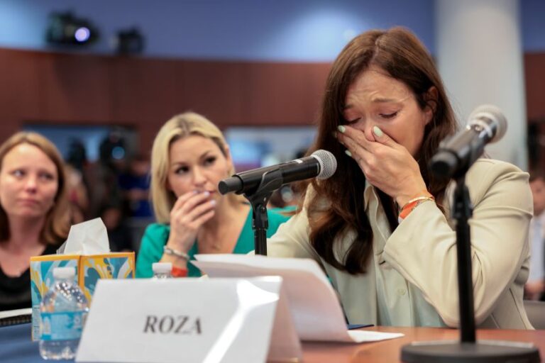 Epstein survivors Lisa-Jena and Dani Hannah Bensky listen as Roza testifies about her experience during a House Oversight Committee hearing with advocates and survivors of Jeffrey Epstein's sexual abuse, at West Palm Beach City Hall in West Palm Beach Florida, on May 12.