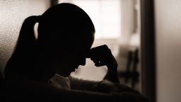 Sad and worried woman sitting on the floor.