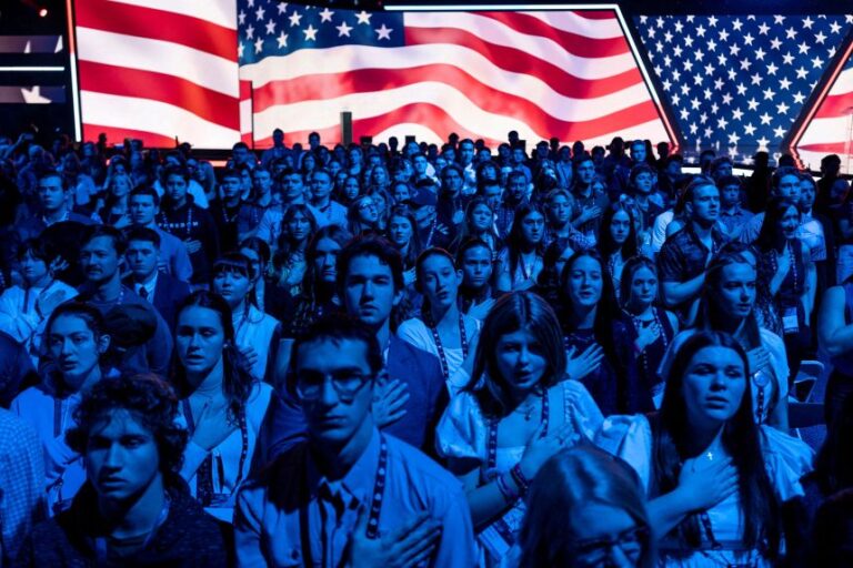 Attendees observe the National Anthem during AmericaFest, the first Turning Point USA summit since the death of Charlie Kirk on December 20, 2025, in Phoenix.