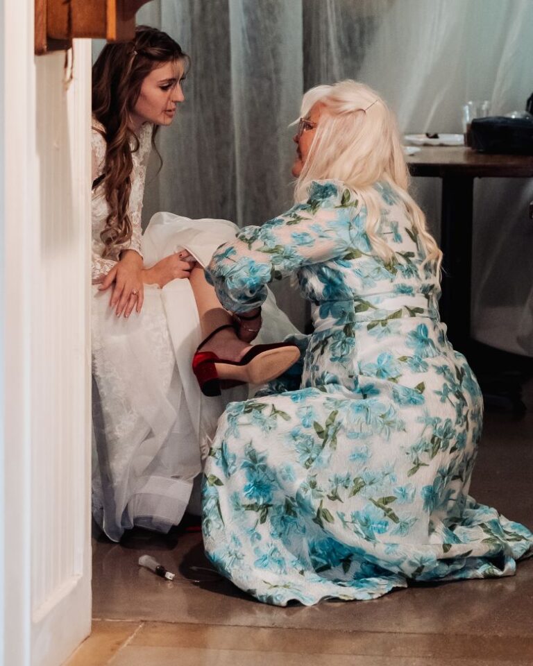 Olivia leans on her mother for support just before her wedding. Her tubing is seen dragging on the floor.